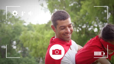 Taking-photos-of-father-and-daughter-in-garden-on-a-digital-camera