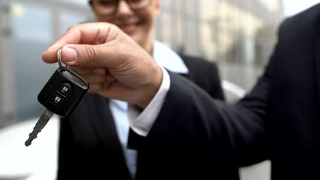 Business-lady-putting-e-signature-on-tablet,-receiving-car-key,-successful-deal