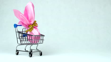 Wrapped-Easter-egg-is-placed-into-the-toy-shopping-cart-during-Resurrection-Sunday-or-Christian-feast-Pascha