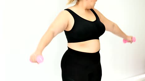 Overweight-young-woman-in-sportswear-exercising-to-lose-weight-at-home