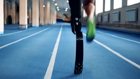 Close-up-of-a-male-prosthetic-leg-and-a-healthy-one-during-jogging