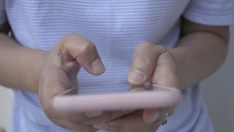 Woman-in-casual-dress-texting-message-on-mobile-smart-phone-for-communication-and-chatting-on-social-online-at-home.