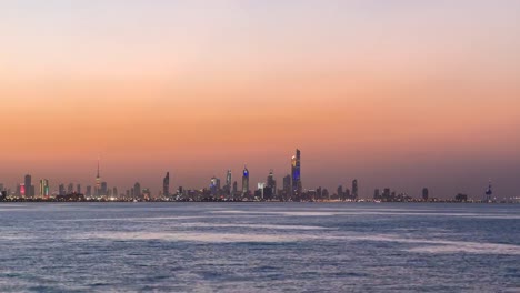 Skyline-with-Skyscrapers-day-to-night-timelapse-in-Kuwait-City-downtown-illuminated-at-dusk.-Kuwait-City,-Middle-East