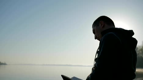 Prayer-for-healing,-faith-in-god,--disabled-man-in-wheelchair-reads-bible-and-raises-hands-to-sky,-faith