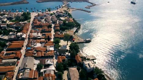 Old-city-with-terra-cotta-tile-rooftops-drone-aerial-view.-Small-coast-city-near-the-sea-with-marina