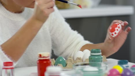 Woman-Decorating-Easter-Eggs-with-Little-Daughter-and-Grandma