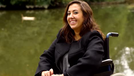 smiling-young-woman-on-wheelchair-at-the-park