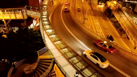 Top-view-of-traffic-on-the-bridge-in-Hong-Kong.-Stock.-Junction-of-a-flyover-and-a-highway-with-vehicle-lights-forming-light-trails-in-Hong-Kong-at-night