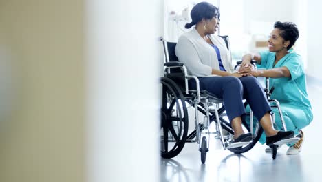 Multi-ethnic-team-with-senior-patient-in-wheelchair