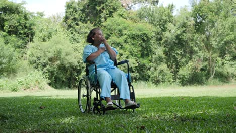 Lonely-disabled-elderly-woman-sitting-on-wheelchair-alone-in-the-park