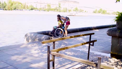 Young-disable-man-on-a-walk-near-the-river-with-his-wife