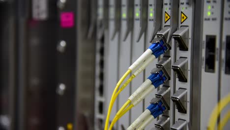 Networking-Temecommunication-fiber-optics-cable-patch-cord-connected-and-blinking-of-led-status-in-data-center