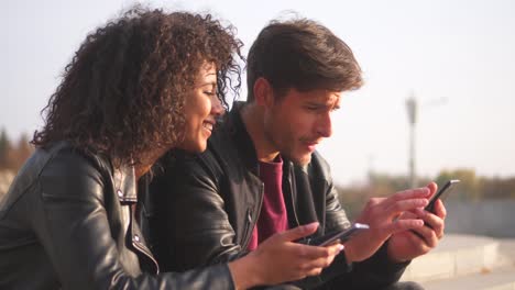 Young-urban-couple-sharing-mobile-phones