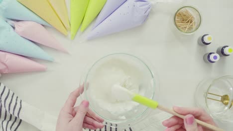 Mixing-royal-icing-to-decorate-Easter-sugar-cookies.