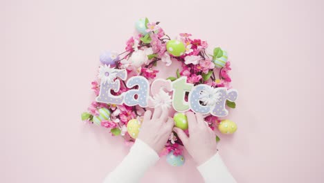 Easter-sign-with-flower-wreath-on-a-pink-background.