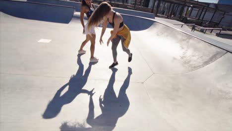 Girls-sliding-down-from-skating-bowl