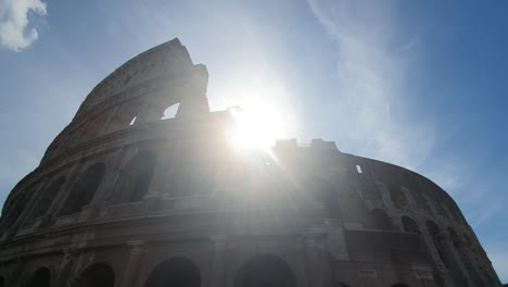 A-ray-of-sun-passes-through-the-arches-of-the-Colosseum-in-Rome,-Italy.