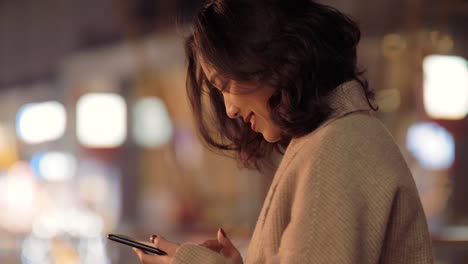 Chinese-girl-using-a-cellphone-and-smiling-in-chengdu