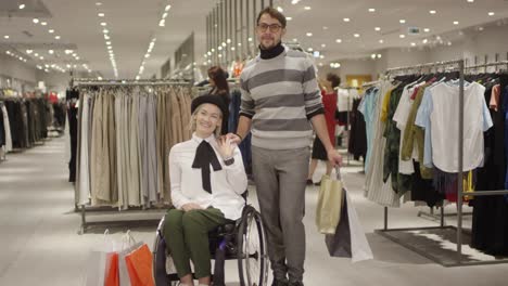 Happy-Woman-in-Wheelchair-and-her-Friend-Posing-in-Clothing-Store