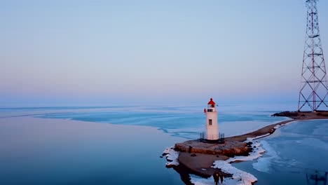 Aerial-winter-view-of-the-Tokarevskiy-lighthouse---one-of-the-oldest-lighthouses-in-the-Far-East,-still-an-important-navigational-structure-and-popular-attractions-of-Vladivostok-city,-Russia.