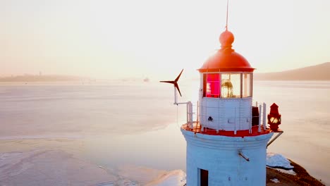 Aerial-winter-view-of-the-Tokarevskiy-lighthouse---one-of-the-oldest-lighthouses-in-the-Far-East,-still-an-important-navigational-structure-and-popular-attractions-of-Vladivostok-city,-Russia.