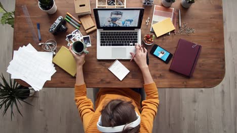 Woman-Listening-to-Music-while-Working