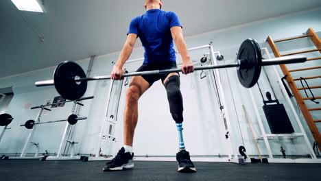 A-man-with-a-bionic-leg-starts-lifting-heavy-weights-in-a-gym