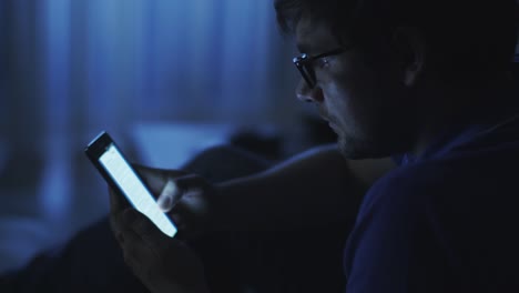 Man-is-Browsing-Internet-on-Phone-at-Night