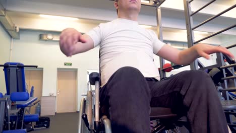 Disabled-man-makes-exercises-for-warming-up-his-hand-before-training.