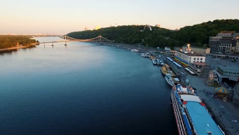 River-port-with-boats-in-the-old-part-of-town-and-green-hills-aerial-drone-shoot