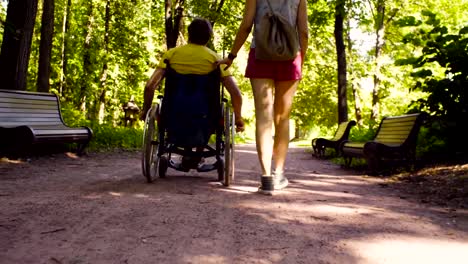 Young-disable-man-with-his-wife-on-a-walk-in-the-park