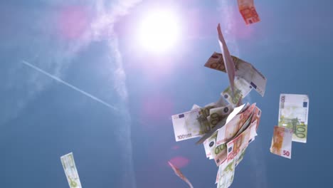 SLOW-MOTION-CLOSE-UP:-Fifty-and-hundred-euro-€-bills-falling-from-the-blue-sky