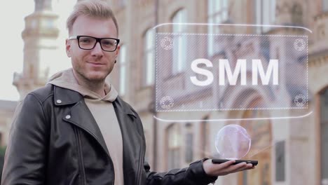 Smart-young-man-with-glasses-shows-a-conceptual-hologram-SMM