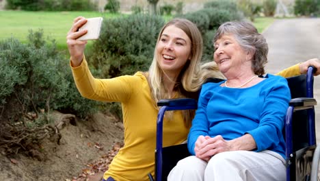 Senior-woman-and-young-girl-taking-selfie-4k