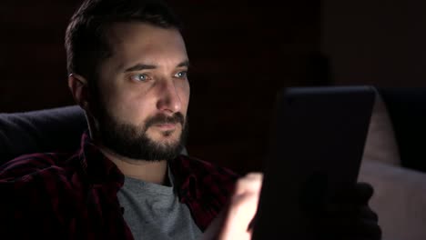 Man-using-digital-tablet-at-night