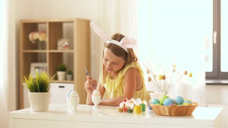 happy-girl-coloring-easter-eggs-at-home