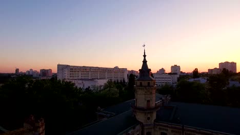 Old-university-on-the-background-of-the-city-at-sunset-aerial