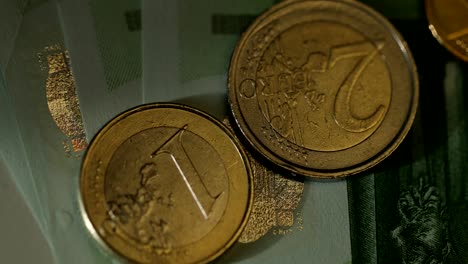 Macro-shot-of-Euro-money,-coins-and-banknotes.-Euro-currency.-Coins-stacked-on-each-other-in-different-positions.-Money-concept.