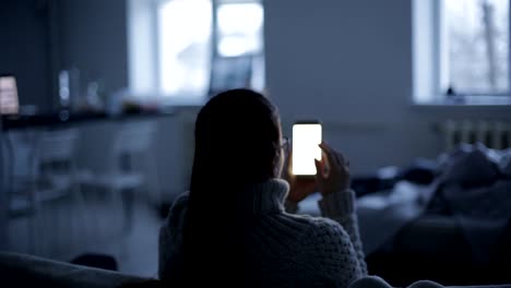 Caucasian-woman-uses-smartphone,-phone-screen-is-reflected-in-glasses-social-network,-technology,-communication-concept