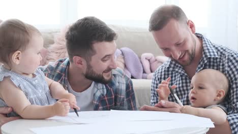 Two-fathers-with-baby-girls-at-home