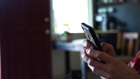 Close-up-female-hand-uses-smartphone-social-media