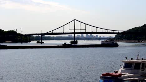 Barge-traffic-along-a-river-with-bridges