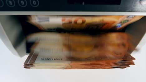 Top-view-of-euro-banknotes-inside-of-the-counting-machine