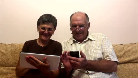 Attractive-adult-woman-and-adult-man-work-on-tablet-pc-and-smartphone.