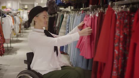 Happy-Woman-in-Wheelchair-Shopping-for-Skirts-at-Clothing-Store