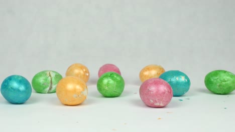 Broken-and-broken-multicolored-easter-eggs-on-white-background,-easter-holiday-graduation-concept,-background