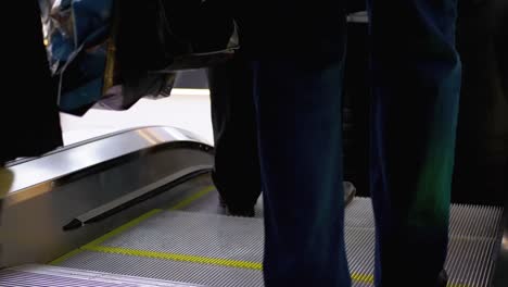 Legs-of-People-Moving-on-an-Escalator-Lift-in-the-Mall.-Shopper's-Feet-on-Escalator-in-Shopping-Center