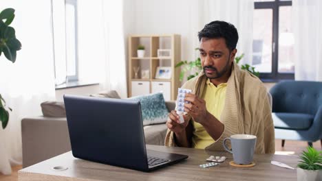 ill-man-with-medicines-having-video-call-on-laptop