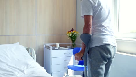 Senior-disabled-man-walking-on-the-crutches-in-the-hospital