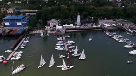 Aerial-view-on-sail-boats-float-on-the-sea.-Calm-sea-and-sail-boats-by-the-pier.-Yachts-and-boats